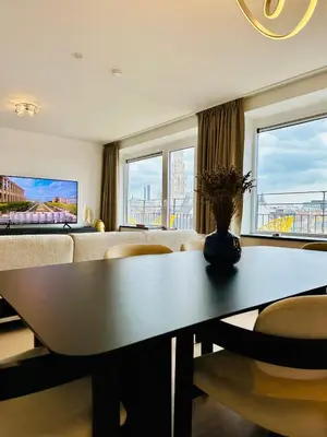 a living room with a table and a couch at Grand Place View - 2bd - Exclusive Apartment in Brussels