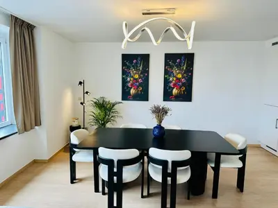 a dining room with a black table and chairs at Grand Place View - 2bd - Exclusive Apartment in Brussels