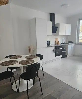 a kitchen with a table and chairs in a room at Brussels apartment with terrace 2 in Brussels