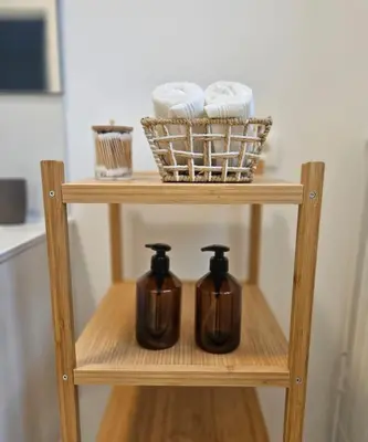 a wooden shelf with two kettles and a basket of towels at Brussels apartment with terrace 2 in Brussels