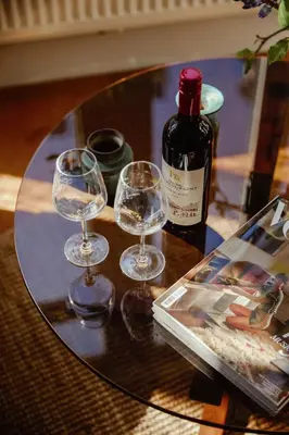 three wine glasses and a bottle on a table at A Place Antwerp - Boutique Suites & Flats - Oude Koornmarkt 1 in Antwerp