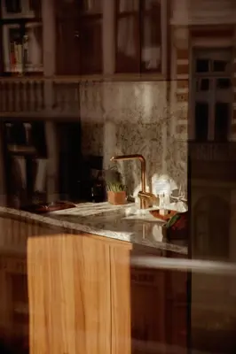 a kitchen counter with a sink and a faucet at A Place Antwerp - Boutique Suites & Flats - Oude Koornmarkt 1 in Antwerp