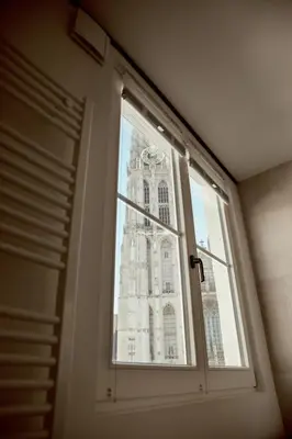 a window with a view of a building at A Place Antwerp - Boutique Suites & Flats - Oude Koornmarkt 1 in Antwerp