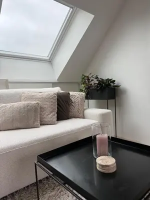 a living room with a couch and a table at Dakappartement V, 2de verdiep TML in Willebroek