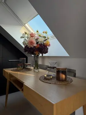 a table with a vase of flowers on top of it at Dakappartement V, 2de verdiep TML in Willebroek
