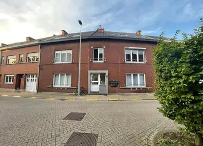 a large red brick building on a street at Dakappartement V, 2de verdiep TML in Willebroek