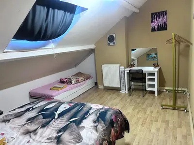a bedroom with a bed and a desk in a room at Nyumbani Stays in Boom