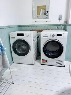 two washing machines sitting next to each other in a room at Nyumbani Stays in Boom
