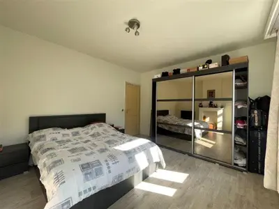 a bedroom with a bed and a large mirror at Nyumbani Stays in Boom
