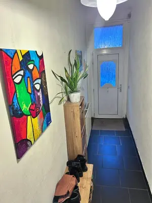 a hallway with a painting on the wall and a table at Nyumbani Stays in Boom