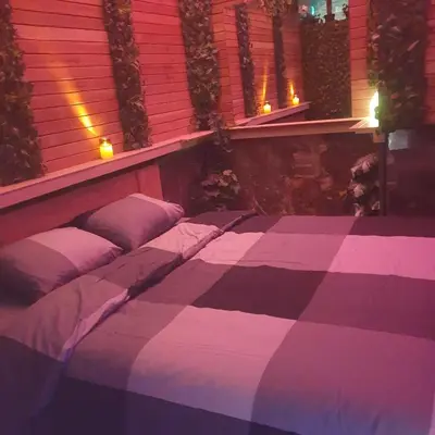 a bedroom with a purple and white bed with pillows at Majestic Wellness Center in Brussels