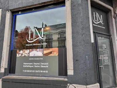 a window of a building with a sign in it at Majestic Wellness Center in Brussels