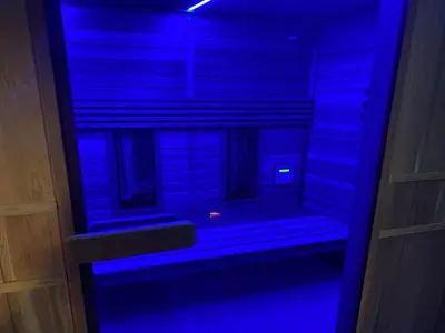 a blue light in a room with a bench at Majestic Wellness Center in Brussels