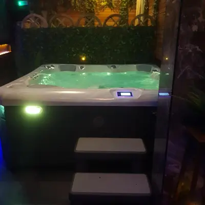 a green bath tub with lights in a room at Majestic Wellness Center in Brussels