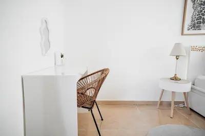 a white room with a chair and a table at Penthouse with a Neo-Gothic Parish church view in Ghent