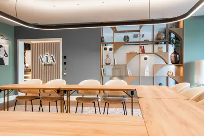 a conference room with a wooden table and chairs at Via Antwerp in Antwerp