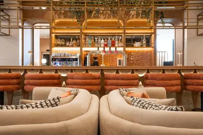 a lobby with two couches and a bar at Via Antwerp in Antwerp