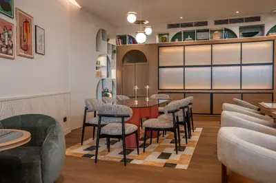 a bar with chairs and a table in a room at Via Antwerp in Antwerp
