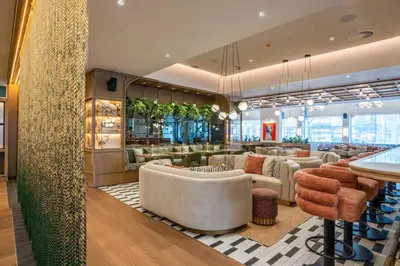a lobby of a hotel with chairs and a bar at Via Antwerp in Antwerp