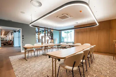 a dining room with wooden tables and chairs at Via Antwerp in Antwerp