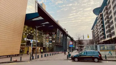 a car parked on a street in front of a building at Midi Station 3 in Brussels