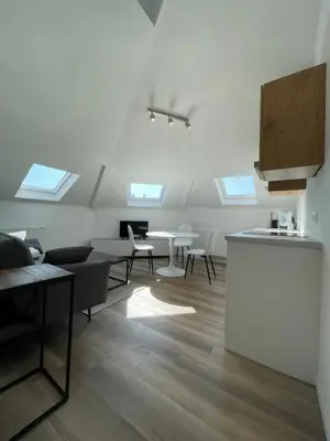 a living room with tables and chairs and windows at Midi Station 3 in Brussels
