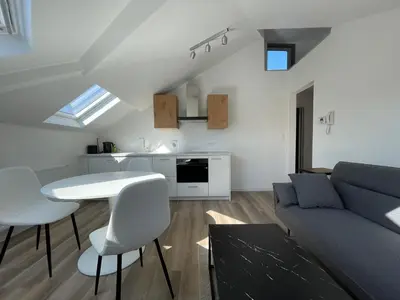 a living room with a couch and a table at Midi Station 3 in Brussels