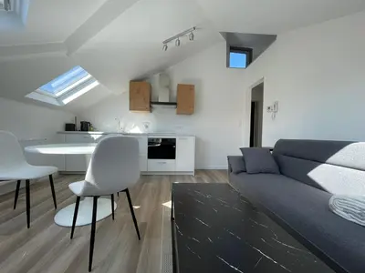 a living room with a couch and a kitchen at Midi Station 3 in Brussels