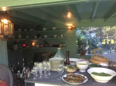 a kitchen with a table with plates and wine glasses at The Secret Garden in Lankom