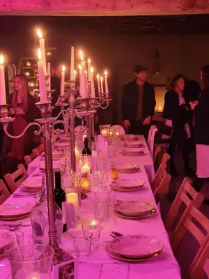 a long table with plates and candles on it at The Secret Garden in Lankom