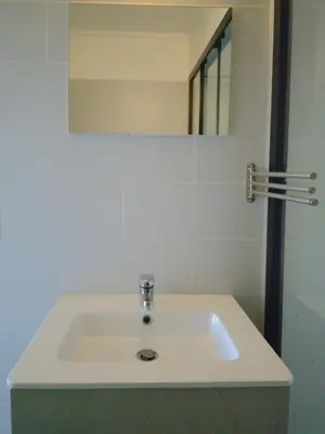 a white sink in a bathroom with a mirror at Bxl central with city views in Brussels