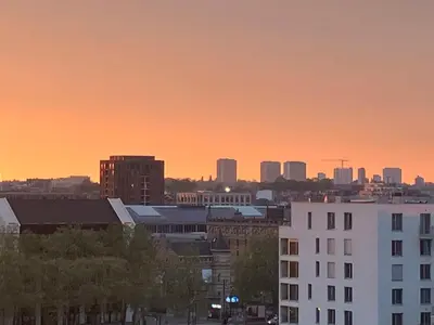 a city skyline at sunset with buildings and trees at Bxl central with city views in Brussels