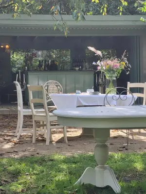 a white table and chairs on a patio at The Secret Garden in Herentals