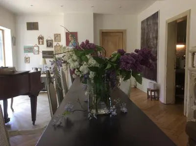 a vase of purple and white flowers on a table at The Secret Garden in Herentals