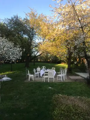 a table and chairs in the grass in a park at The Secret Garden in Herentals