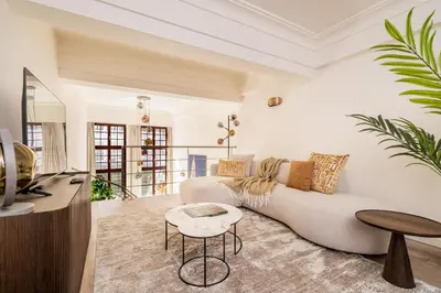a living room with a couch and a table at Heritage Suites Antwerp in Antwerp