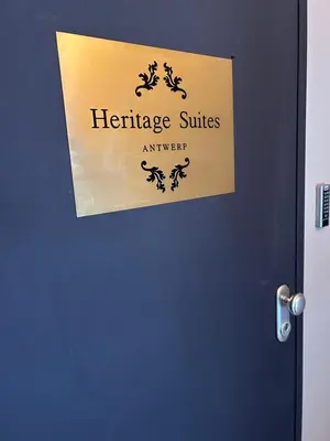 a sign on a door that reads heritage suitesenger at Heritage Suites Antwerp in Antwerp