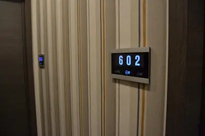 an alarm clock on the wall of a room at The Helmet Hotel in Brussels