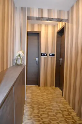 a hallway with two elevators and two doors in a building at The Helmet Hotel in Brussels