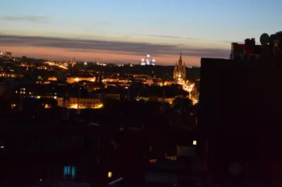 a view of a city at night at The Helmet Hotel in Brussels