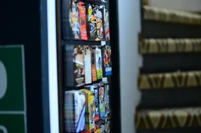 a shelf full of video games at The Helmet Hotel in Brussels