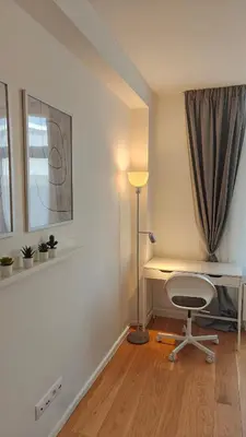 a room with a desk and a chair and a lamp at Highgarden - warm & cozy in Brussels