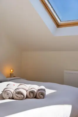 a bedroom with a bed with towels on it at Stylish 1BR close to KMSKA in Antwerp