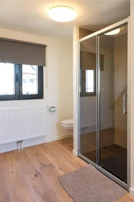 a bathroom with a shower and a toilet at Stylish 1BR close to KMSKA in Antwerp