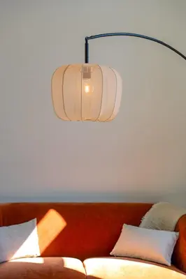 a lamp hanging over a couch with pillows at Stylish 1BR close to KMSKA in Antwerp