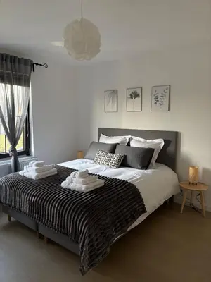 a bedroom with a large bed with towels on it at Cozy Loft Grimbergen in Grimbergen