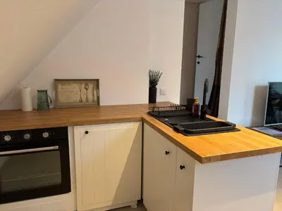 a kitchen with a counter top with a stove top oven at Cozy Loft Grimbergen in Grimbergen