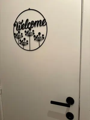 a sign for a bathroom on a white wall at Cozy Loft Grimbergen in Grimbergen