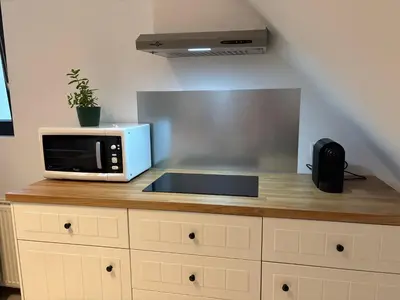 a microwave sitting on top of a kitchen counter at Cozy Loft Grimbergen in Grimbergen