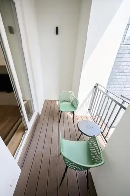 two chairs and a table on a balcony at Toison d'Or in Brussels